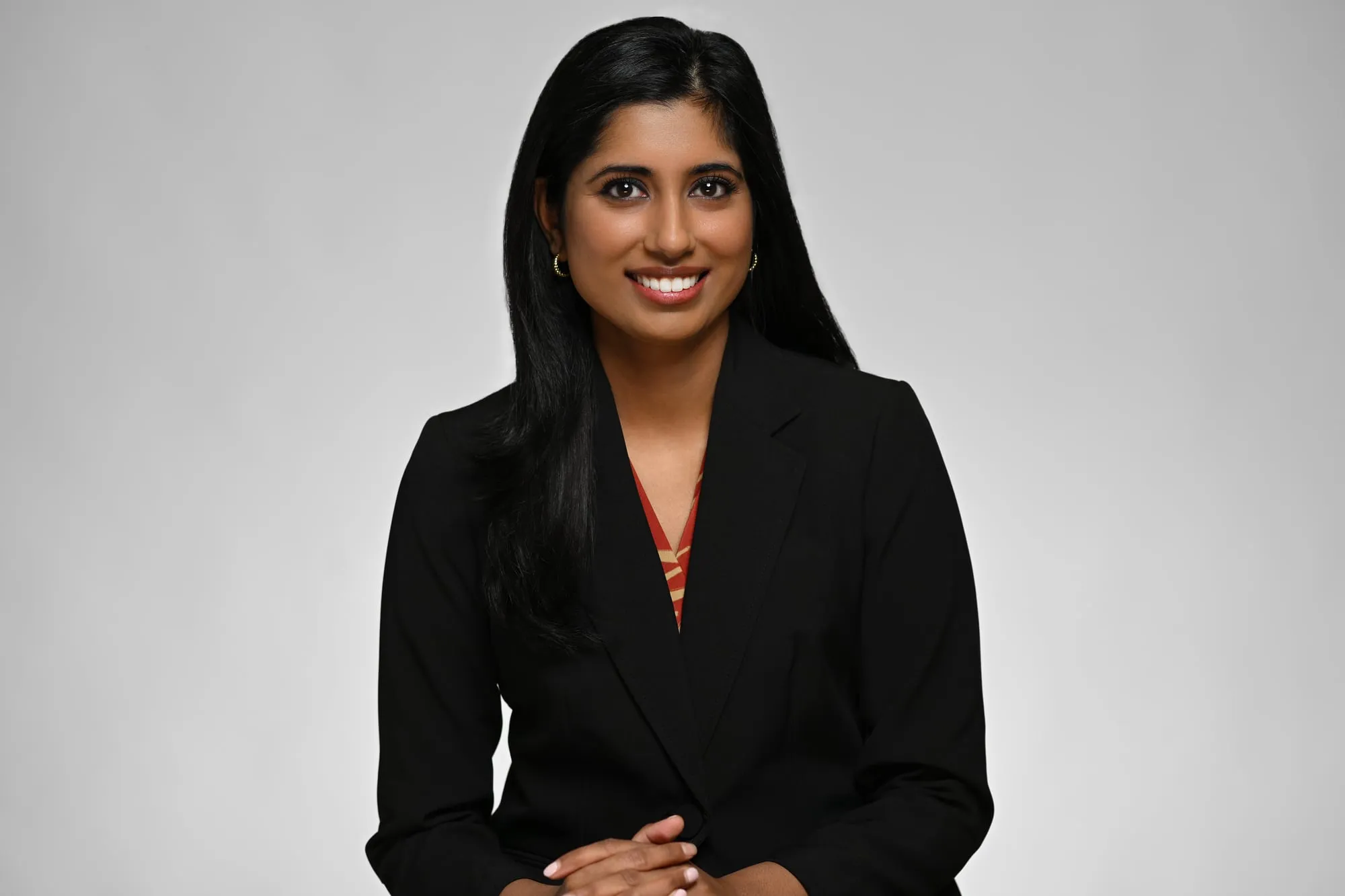 ERAS-ready medical residency headshot: black blazer, grey background