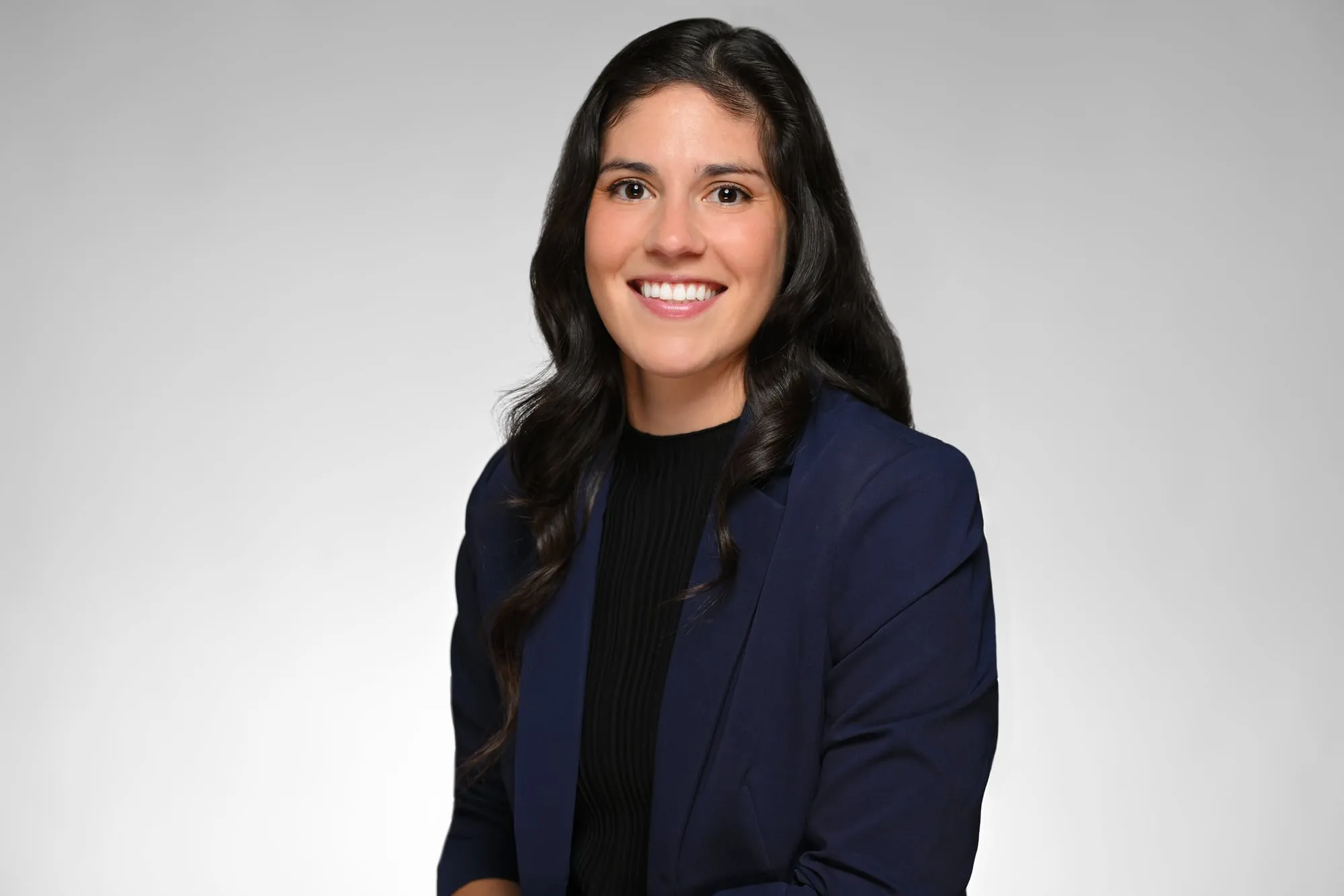 ERAS-ready medical residency headshot: navy blazer, grey background