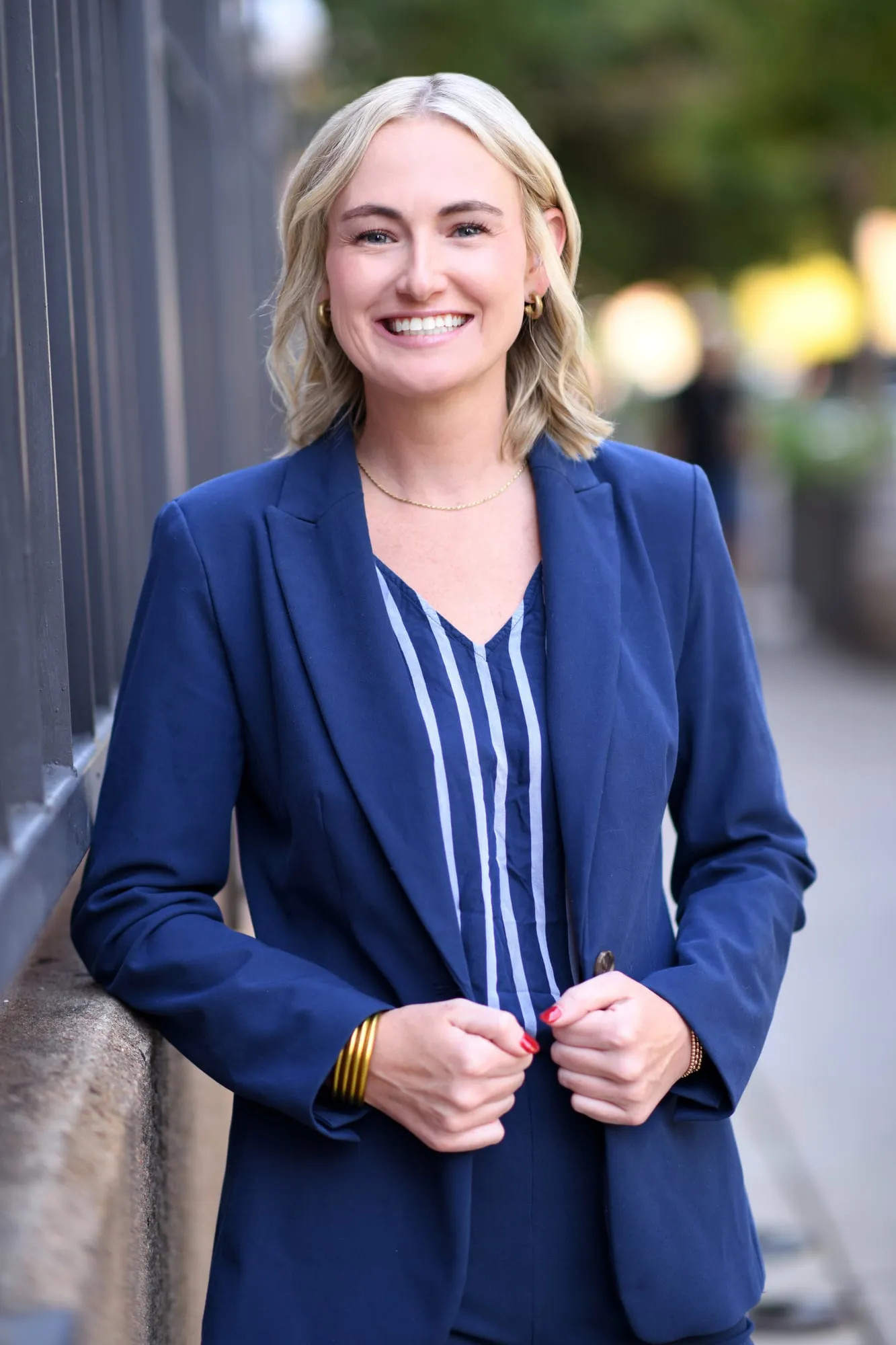 On-location headshot in Denver: blue blazer on a tree-lined city sidewalk
