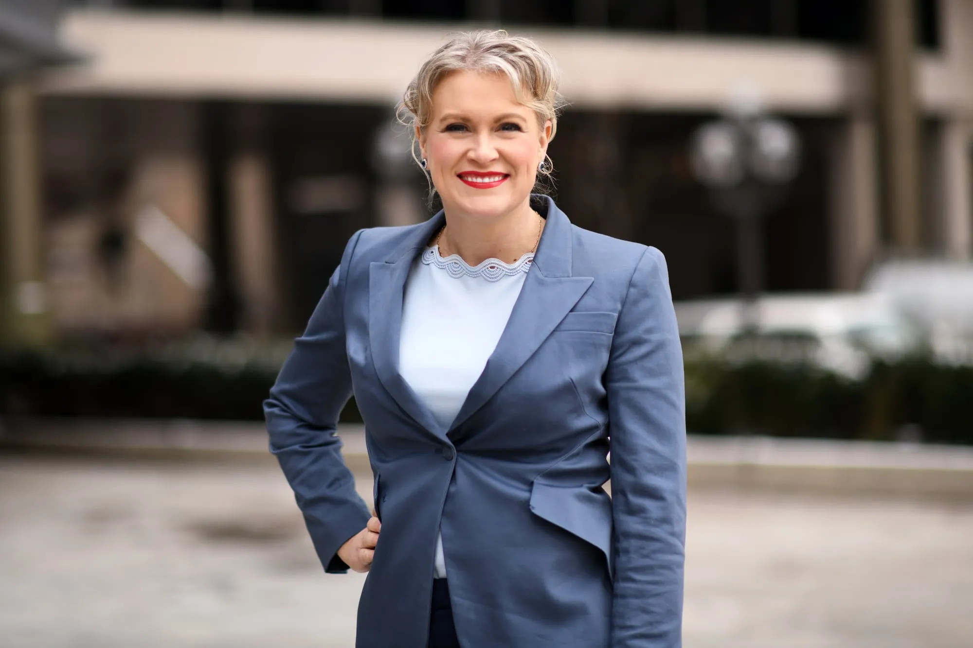 On-location headshot in Denver: grey suit at a building entrance