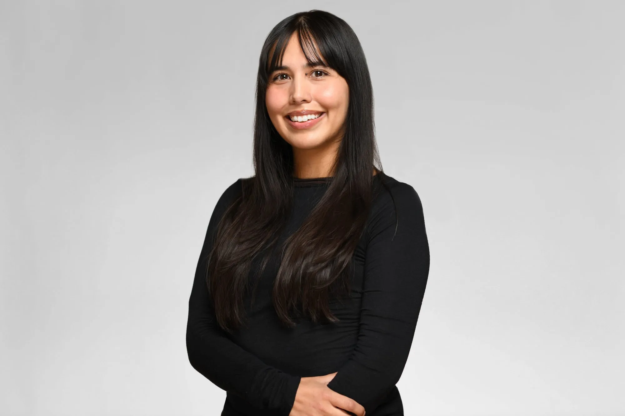 Corporate headshot for Tract in Denver on a light grey background: black top